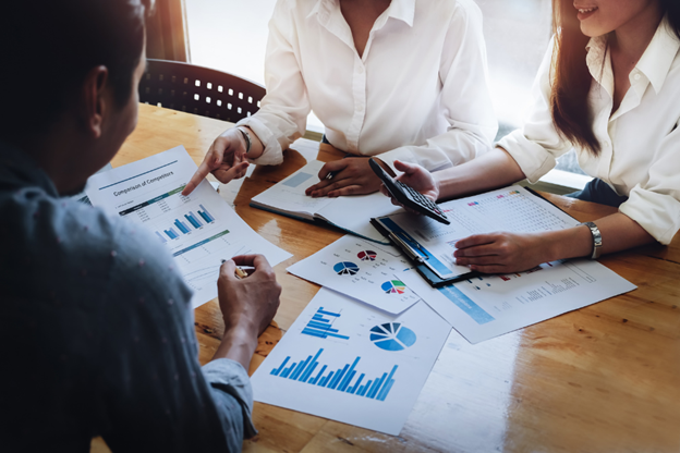 People sitting at a table looking over data