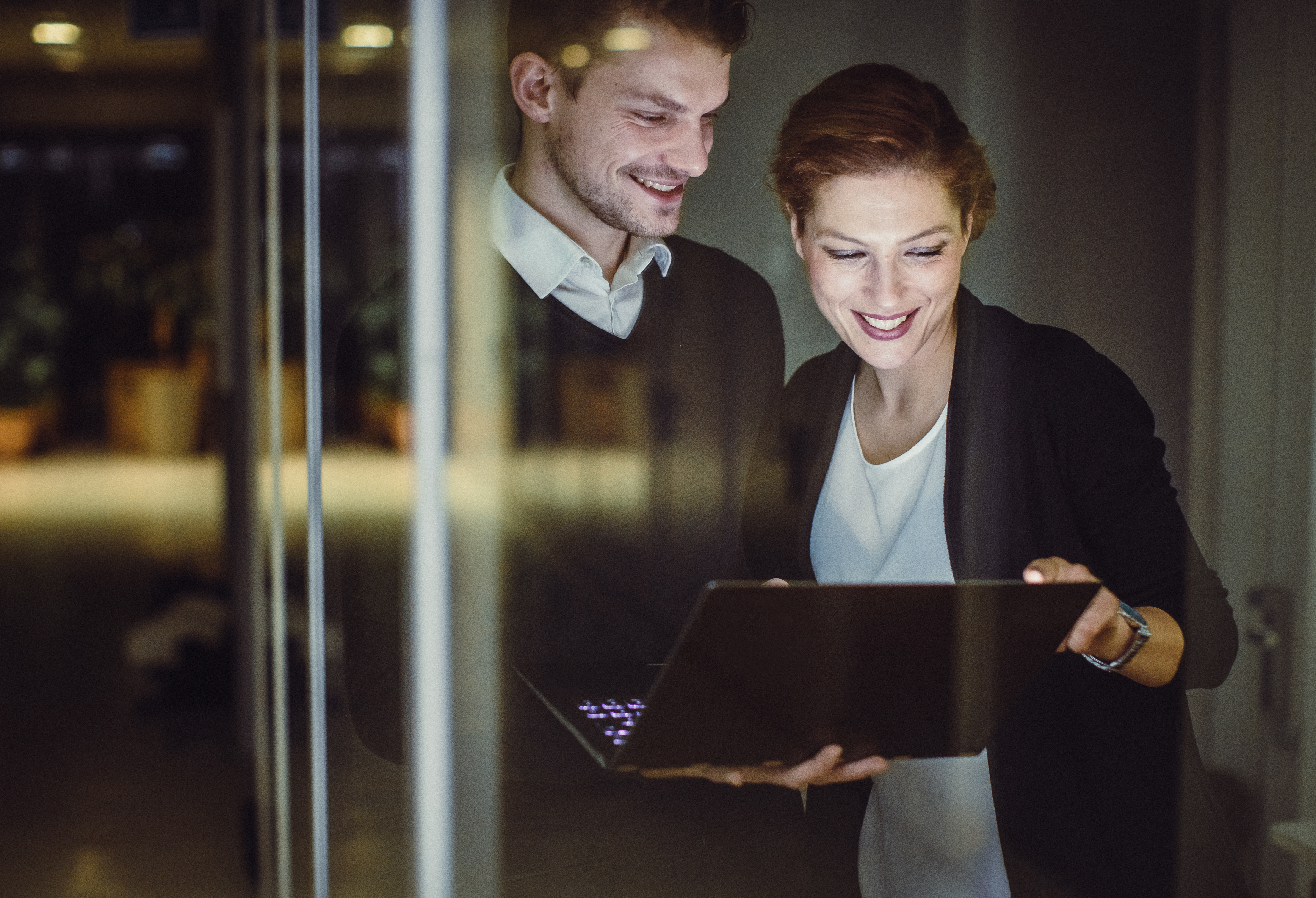 business man and business woman on laptop